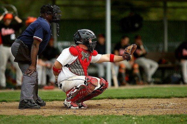 baseball catcher using his body to frame a pitch